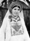 Palestine: A Palestinian woman wearing an embroidered dress, c. 1920